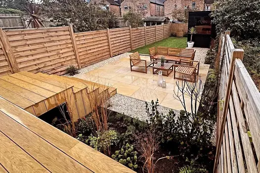 Harvest smooth sandstone paving shows how it comes alive in the wet in this humble garden by Agents Green.