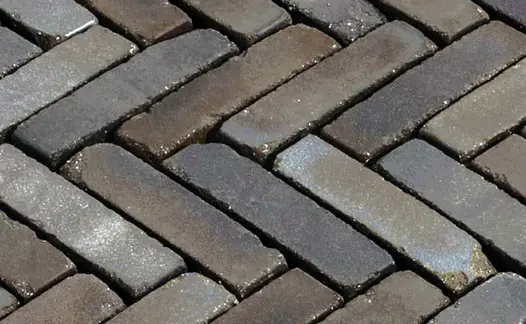 Close-up of wet Ancona Belgian bricks laid herringbone, showing grey and brown colours. Free UK delivery available. 