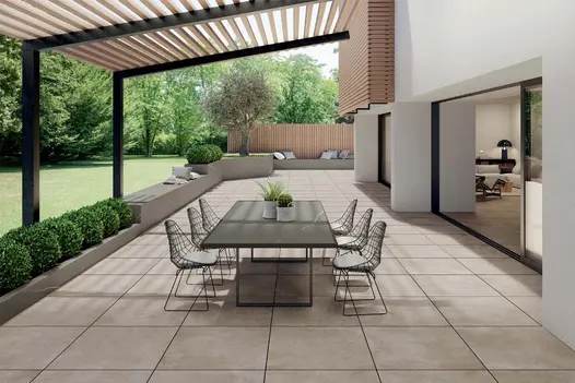 800x800 Porcelain Patio terrace immediately adjacent to large sliding patio doors and a retaining wall leading to a raised garden.