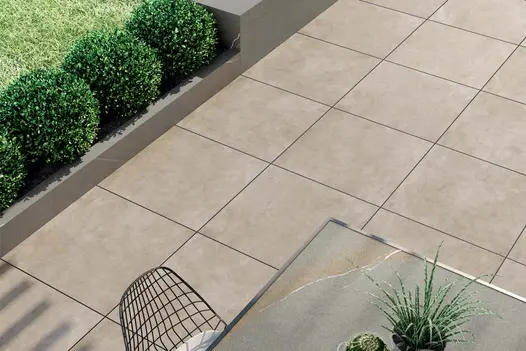 Area 800x800 porcelain pavers laid in a stacked bond with contrastingly coloured dark grout lines enhancing the light paving colour.