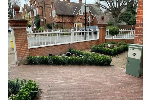 Front garden of corner house. 3 beds planted with hedging. Drive laid at angle with Roma Clay Pavers. Built by AS Landscapes.