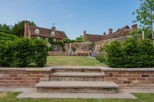 Autumn Brown garden patio paving used as 3 steps between 2 levels of lawn at rear of rural house. 