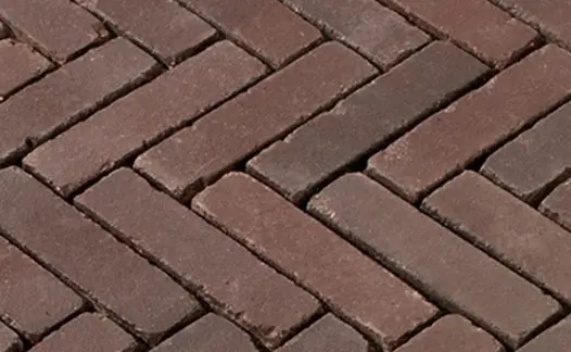 Close view of wet Bergamo  Dutch clay pavers laid herringbone, showing muted red and grey tones. Free UK delivery available.