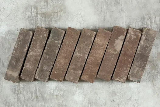 9 Bergamo clay paving bricks, showing grey and red tones, placed side by side against pale background. Free UK delivery available.