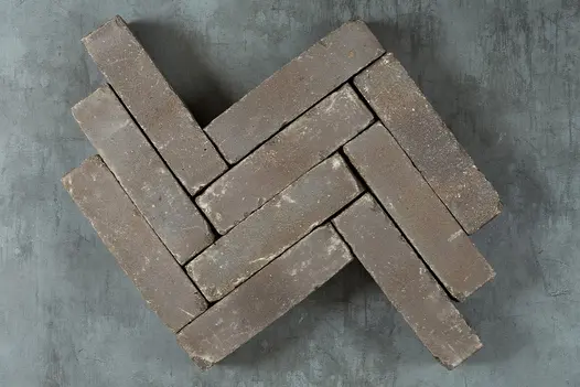 9 Lugano Belgian bricks placed edge-on in 3 rows, zigzag pattern, showing texture and brown colour. Free UK delivery available.
