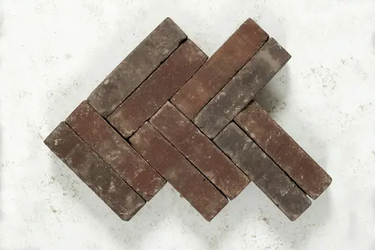10 Bergamo brick pavers laid on edge in 3 courses of double herringbone pattern on grey background. Free UK delivery available.