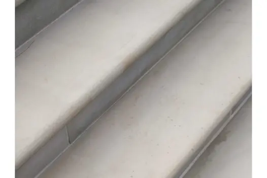Close view of Beige Sawn Sandstone 40mm bullnose step treads, with matching mortar. Designed and built by Artisan Landscapes.