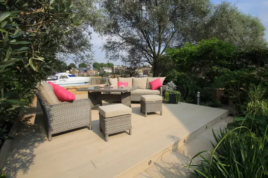 River views from limed oak millboard deck, hosting lounge area covered by trees and hedges for privacy.