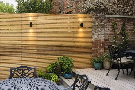 Metal chairs on composite deck of DesignBoard Traditional with 2 steps down to Florence Storm paving. Design by Jaki Grosvenor.