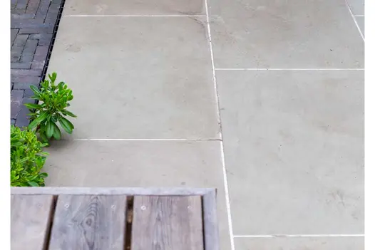 Close view of Heath sawn sandstone 900x600 slabs next to area of clay pavers. Built by Acacia Gardens to Daniel Shea design.
