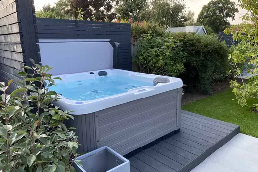 Water bubbles in grey and white hot tub on Dark Ash Brushed DesignBoard garden decking, Design and build by Limebok Landscaping.