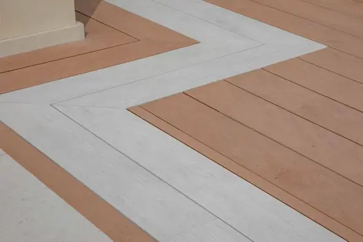 Two board wide strip of polar designboard runs through mocha decking showing off colour and lined texture.