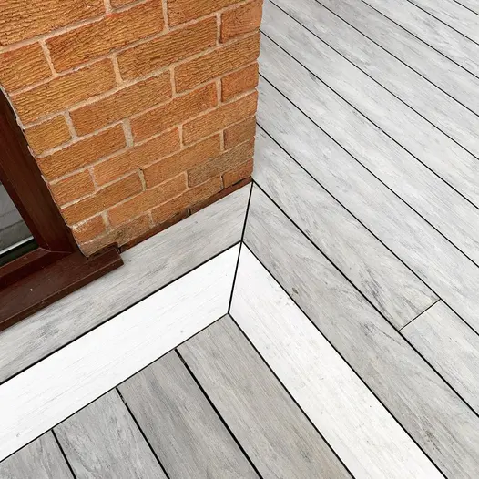 Close up view from corner of red brick house shows detailing and colour of luna designboard composite dekcing.