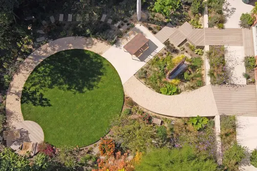 2 descending paths converge at patio and then half edge round lawn, ending in round composite deck of Traditional DesignBoard.