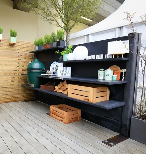 Garden House Design Trade Stand uses Luna DesignBoard Composite decking on their display featuriung potted plants and green egg BBQ.