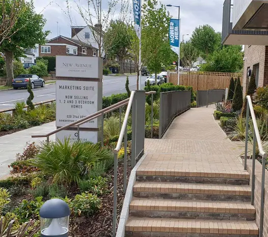 Steel railings and hedging edge crossing of 2 paths of Westminster Clay Paving, built by O’Halloran and O’Brien.