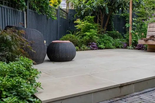 Clay paver path and planted border edge raised patio of Heath sawn sandstone slabs. Design by Daniel Shea, built by Acacia Gardens.