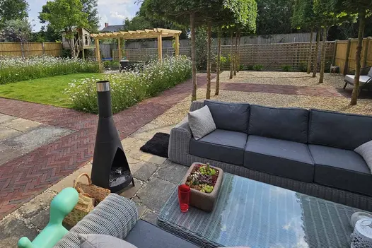 Large back garden, partly laid to gravel and paving, with Winton clay paving paths leading past lawn and to seating areas.