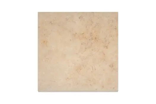 Looking down on a 600x600 Jura Beige porcelain paving slab showing the beige base colour with occasional darker veins.
