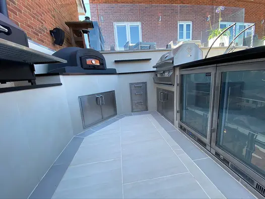 Low level view of floor of outdoor bar area using desert beige designclad on walls, darker porcelain paving used on floor.