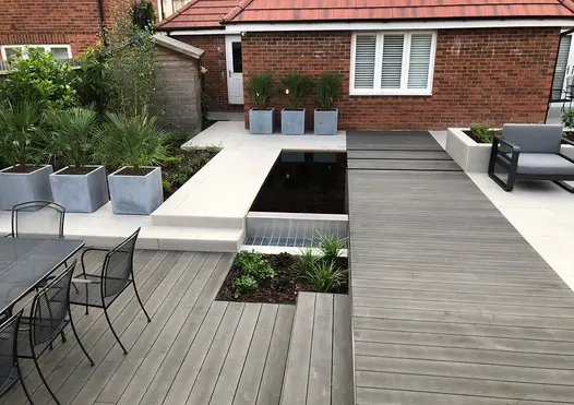 Back garden on 2 levels paved with Charcoal DesignBoard and Florence grey porcelain with cube planters and modern garden furniture.