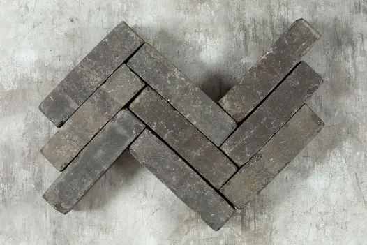 9 Raj Green sandstone patio bricks placed in 3 rows, zigzag pattern, against dark background. Free UK delivery available.