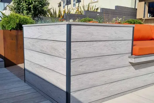 Corner of built in bench and flowerbed using luna designboard composite decking to clad the outside as well as used as decking.