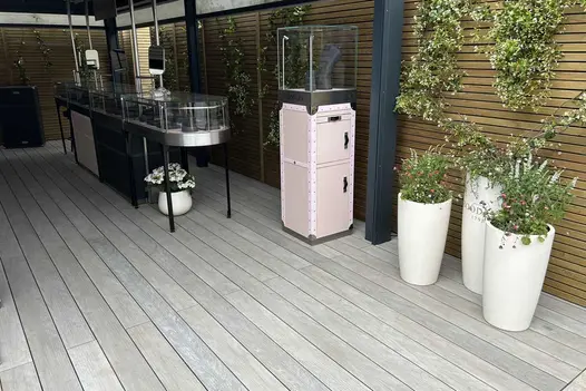Display cabinets and tall planters under cover, on Luna DesignBoard light grey composite decking.