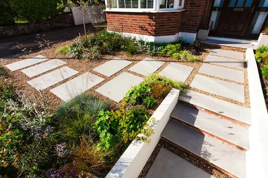Front garden with Florence Grey slabs laid individually into gravel. Design by Jaki Grosvenor. Built by Nordland Landscapes.