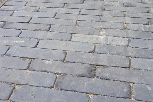 Close-up of grey Lucca clay paving, laid stretcher bond fashion, showing even colour. Free next-day UK delivery available.