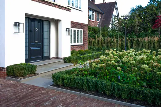 Clay Pavers are lined with Heath Patio Edging with same stones used as paving slabs, leading to front door.