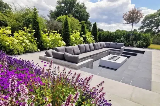 Sunken seating area paved in Slab Coke porcelain outdoor tiles with dark grey paving surround. Design by Bancroft Lee Landscapes.