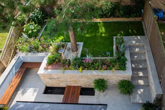 Birds eye of multi level garden with raised planters and walls, coping stones in silver grey with pencil round edges.