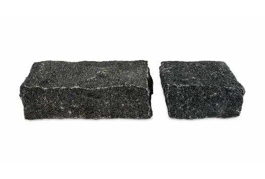 Two sizes of Natural Black Granite Setts on white background show off the riven texture and colour of these cobble stones.